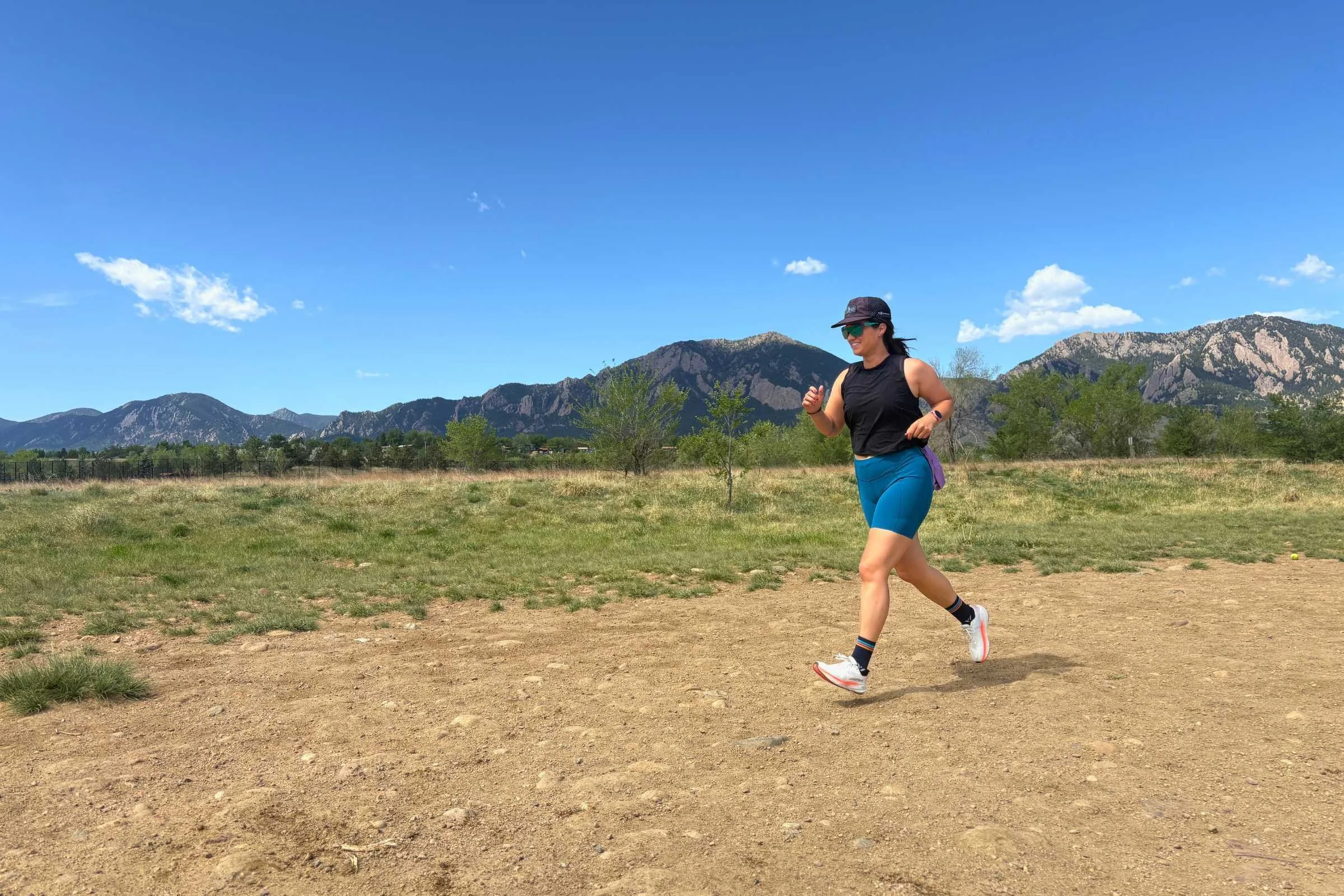 A runner on a scenic trail path, showcasing varied terrain testing.