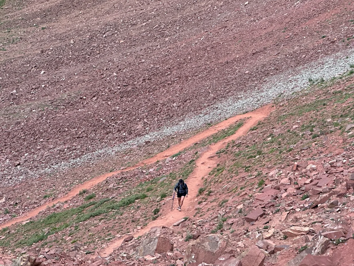 The distinct reddish-brown landscape of West Maroon Pass in the Maroon-Snowmass Wilderness.