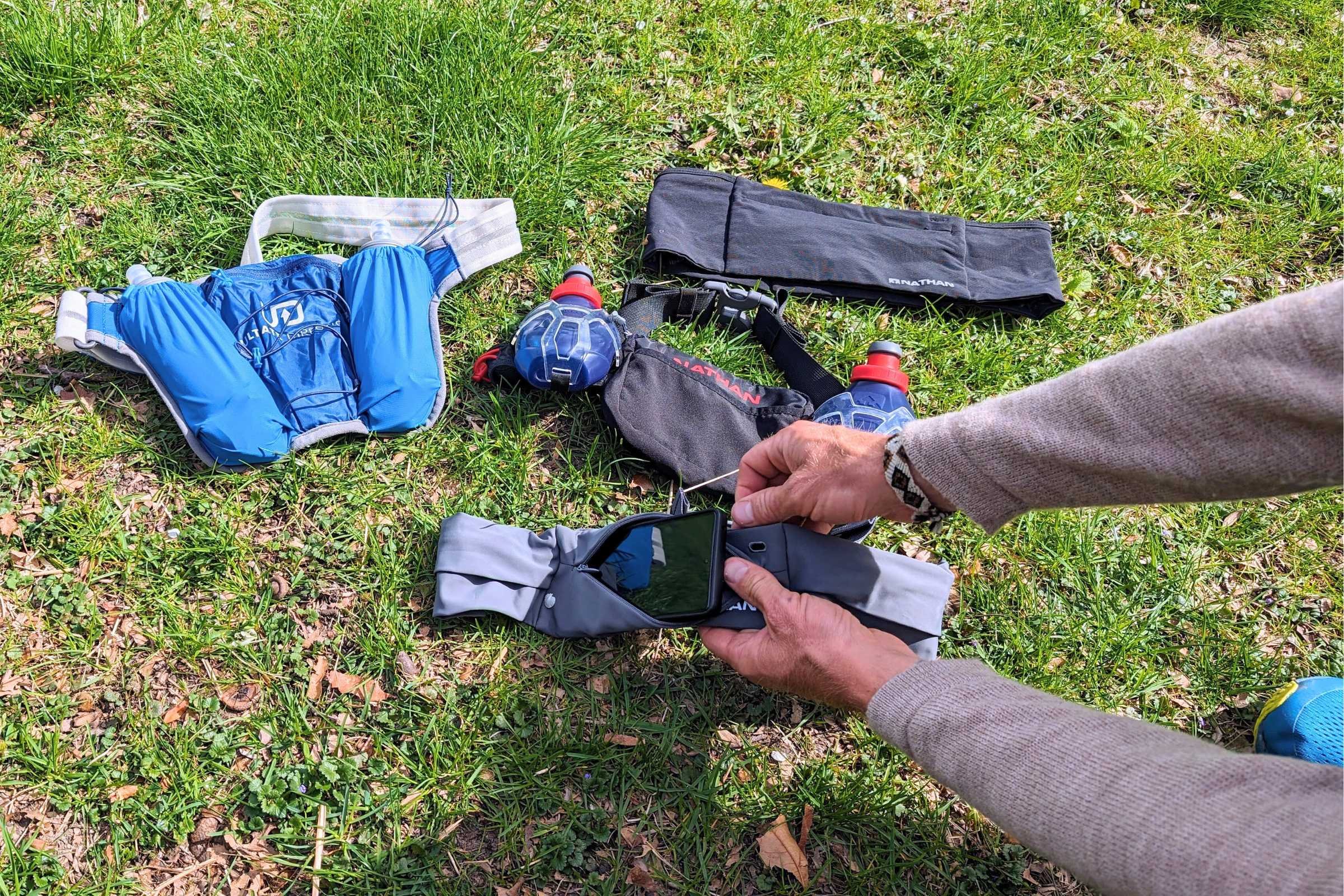 Multiple running belts arranged to show different zipper pocket sizes and security features.