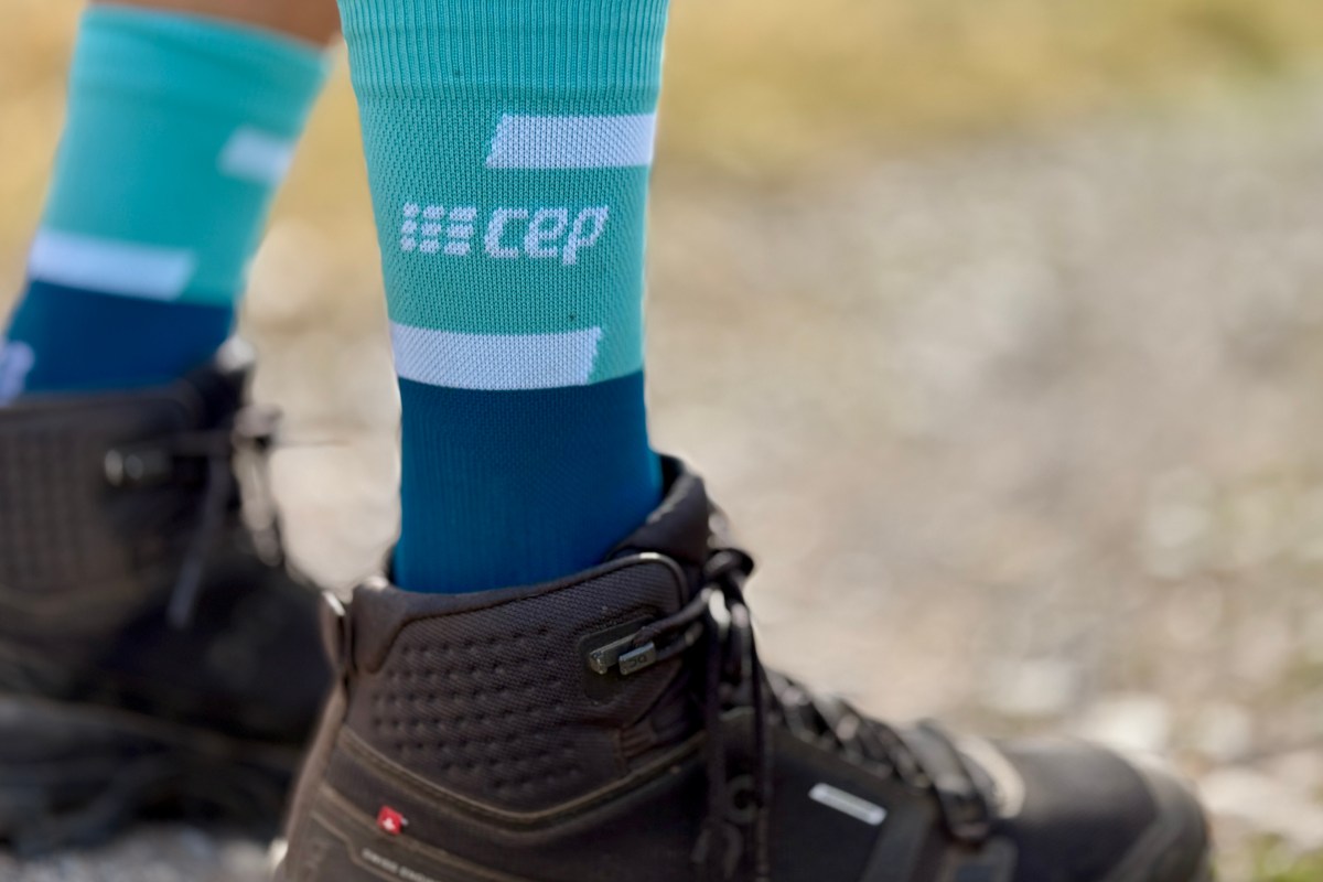 A hiker wearing tall compression socks for increased circulation and muscle support.