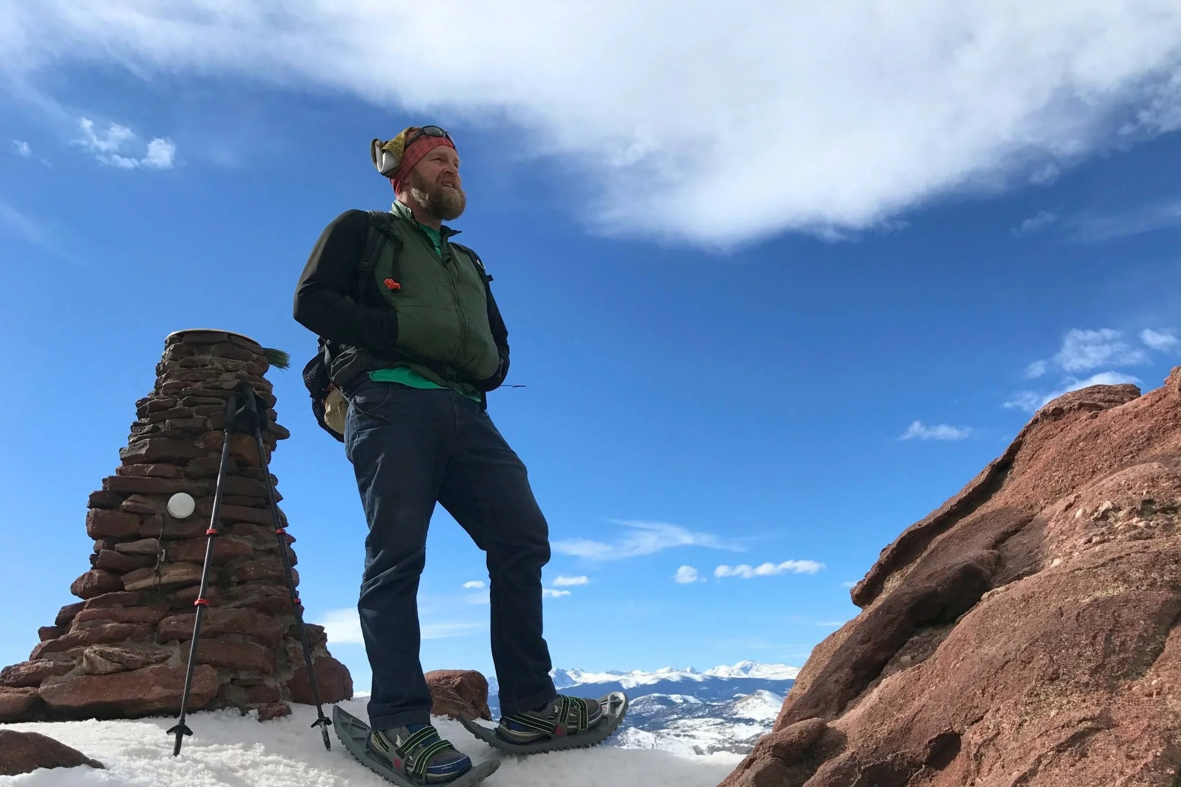 A tester snowshoeing on a mountain with Crescent Moon foam snowshoes.
