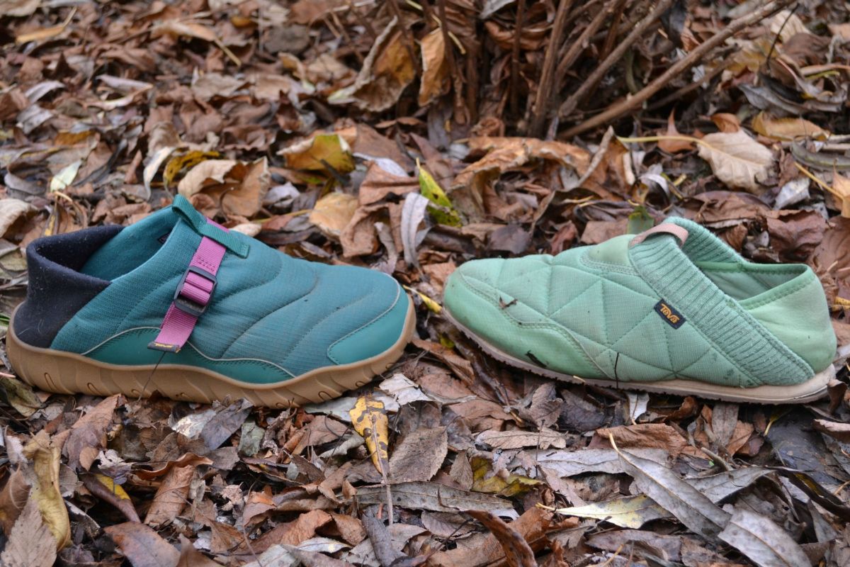 Two Teva ReEmber slippers sitting on the ground in a natural outdoor setting.