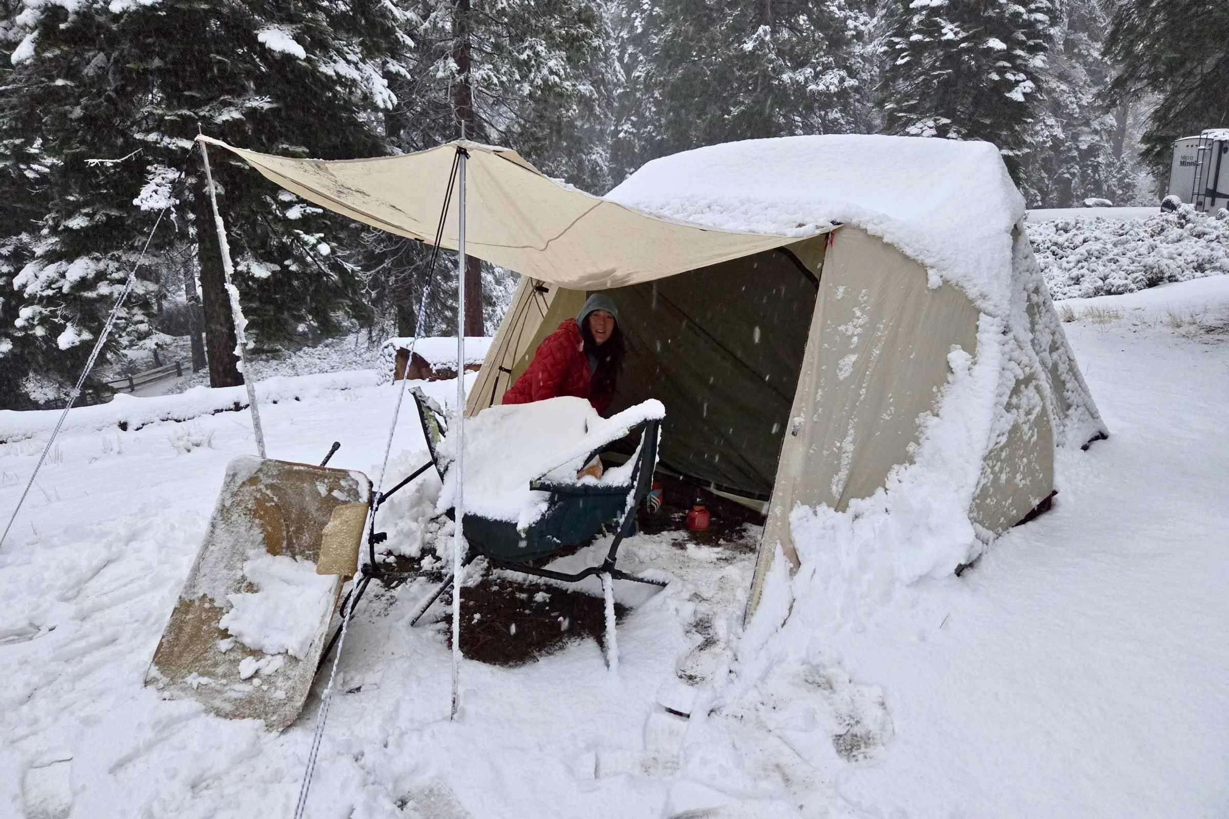 A geodesic camping tent effectively shedding heavy snow during a winter storm test.