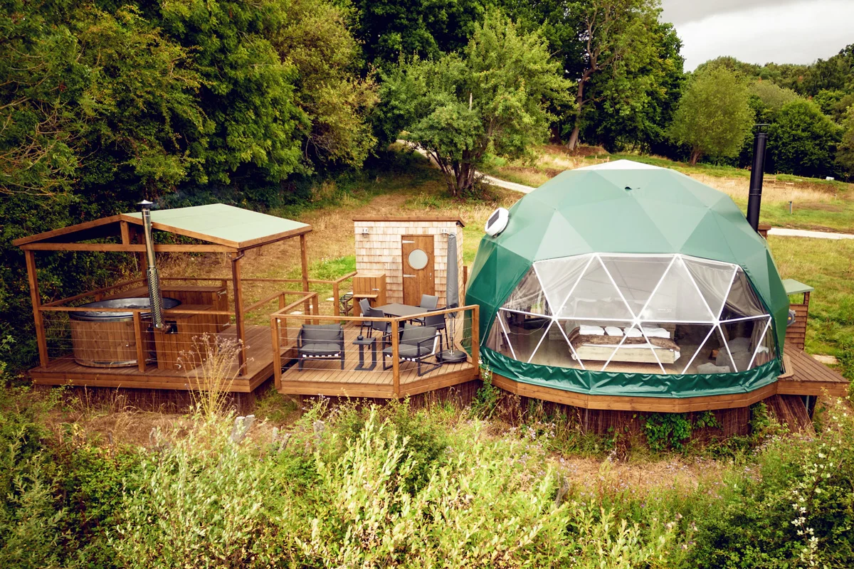 A modern white geodome glamping unit at Luna Domes in the High Weald.