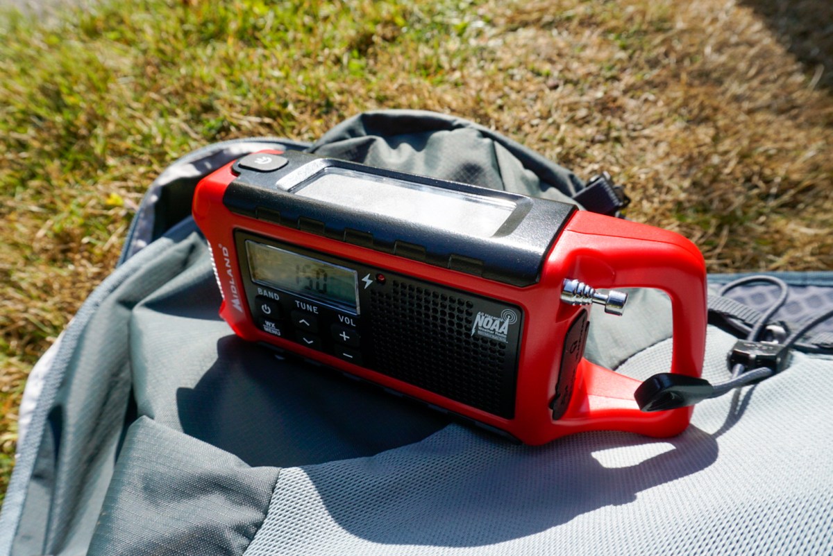 The front interface and speaker mesh of a Midland ER210 emergency radio.