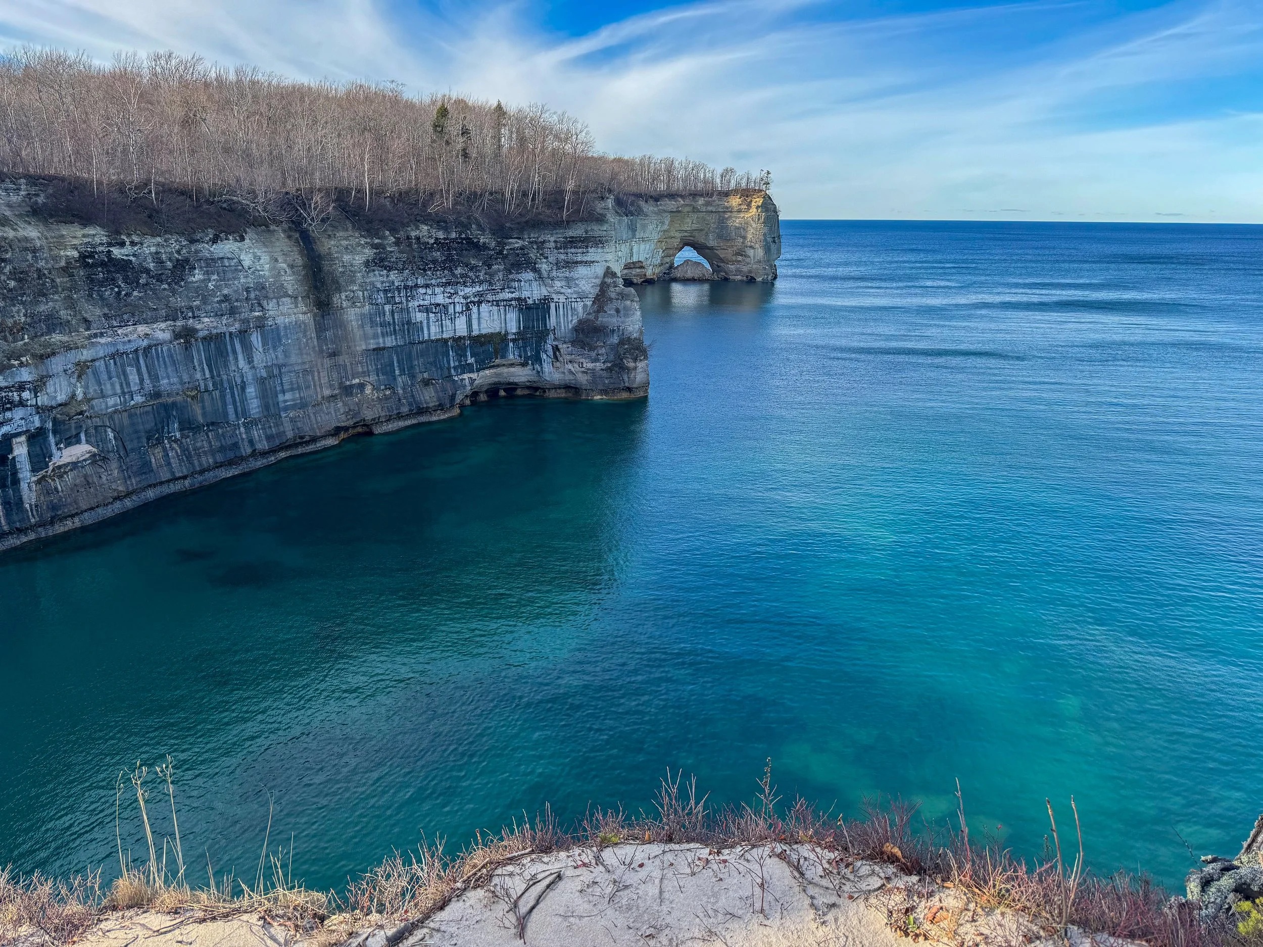 Aerial view of Grand Portal Point and the turquoise waters of Lake Superior.