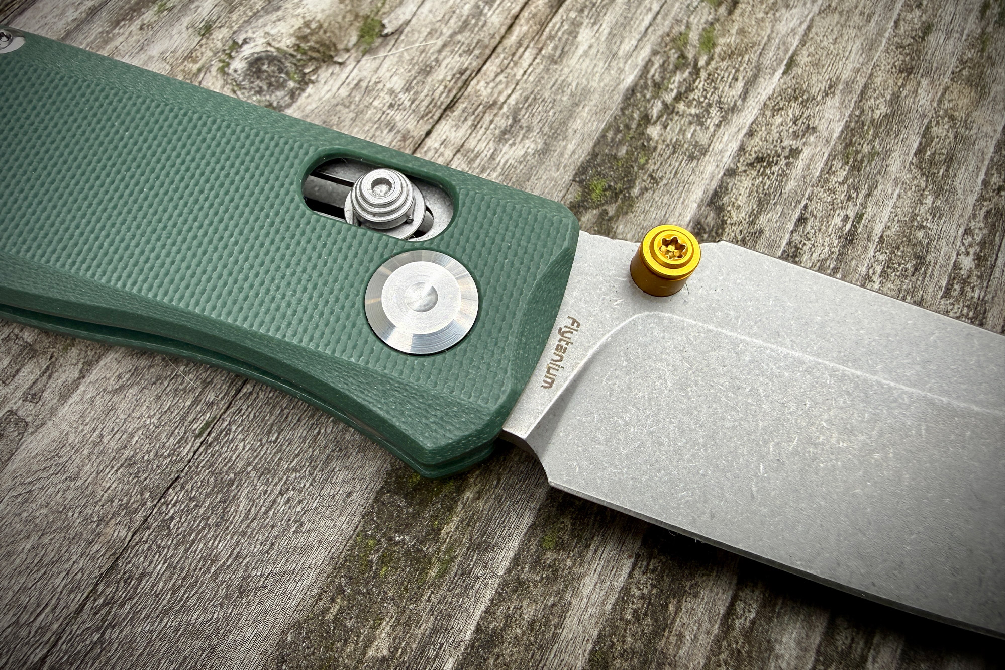 Close-up detail of the Flytanium handle pivot area and textured G10 scales.