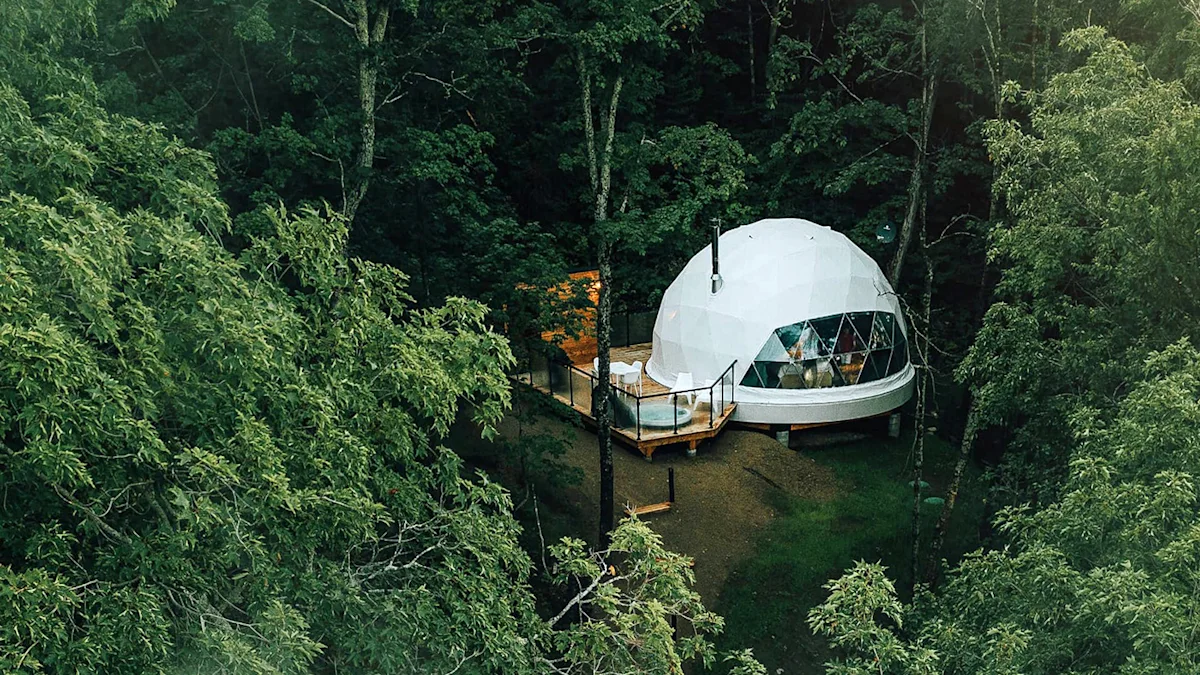 A large-scale Fdomes glamping geodesic structure with a panoramic window view.