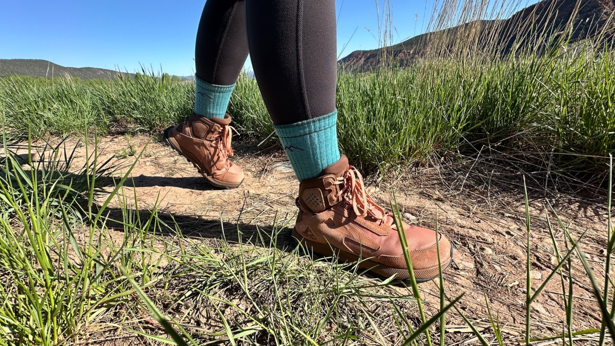 Someone hiking in Darn Tough Micro Crew Midweight socks through a wooded area.