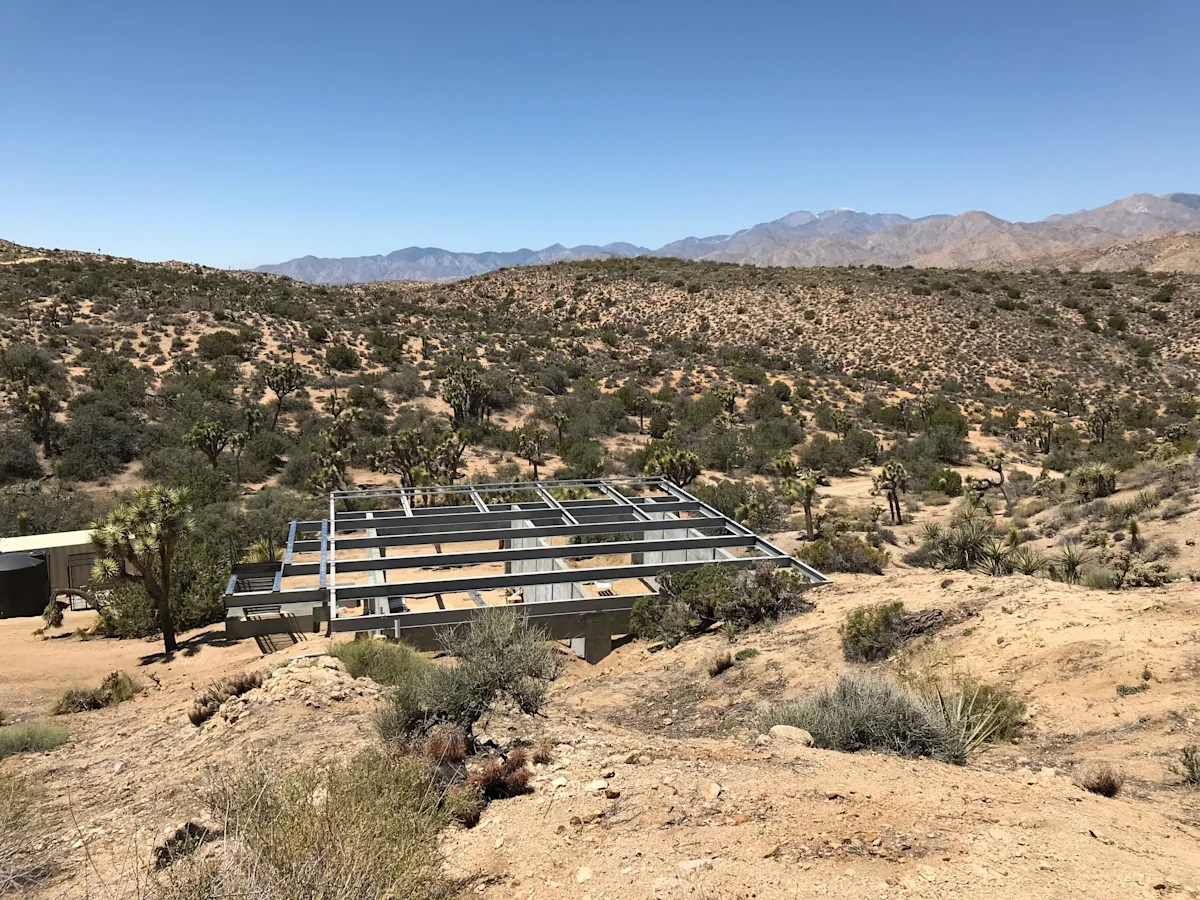 Construction site showing the foundation preparation for a shipping container home.