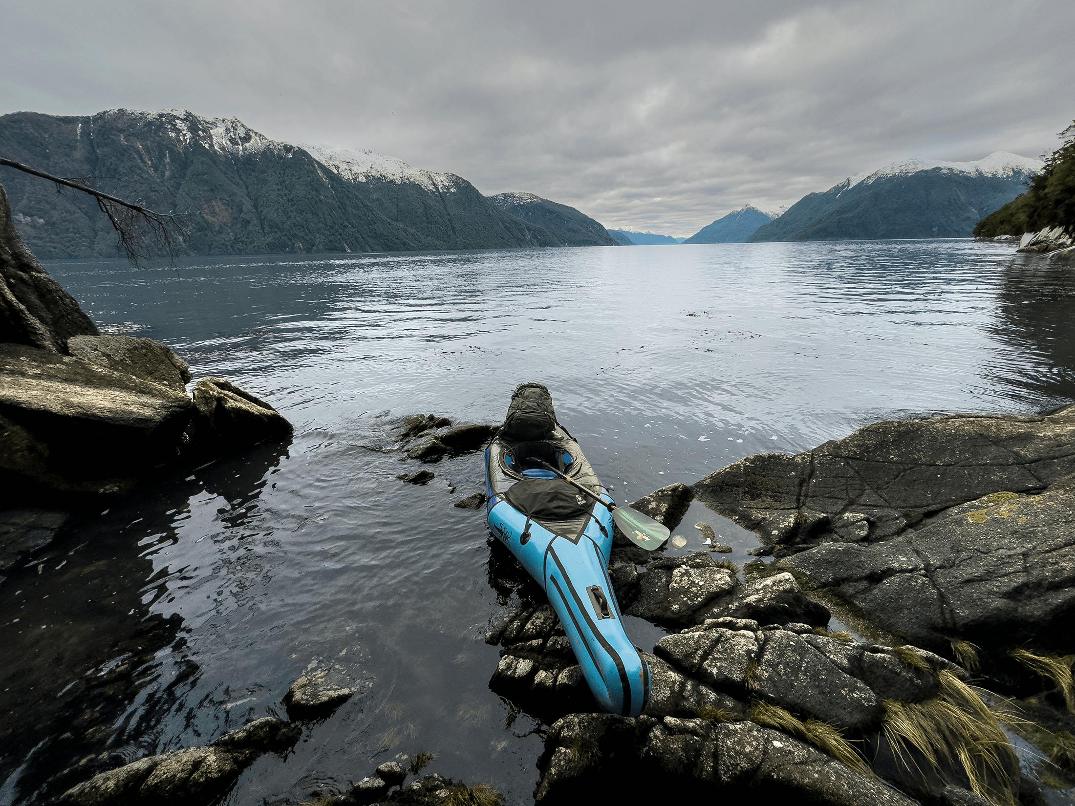 An Alpacka Aleutian packraft sitting next to whale bones on a remote beach in Patagonia.