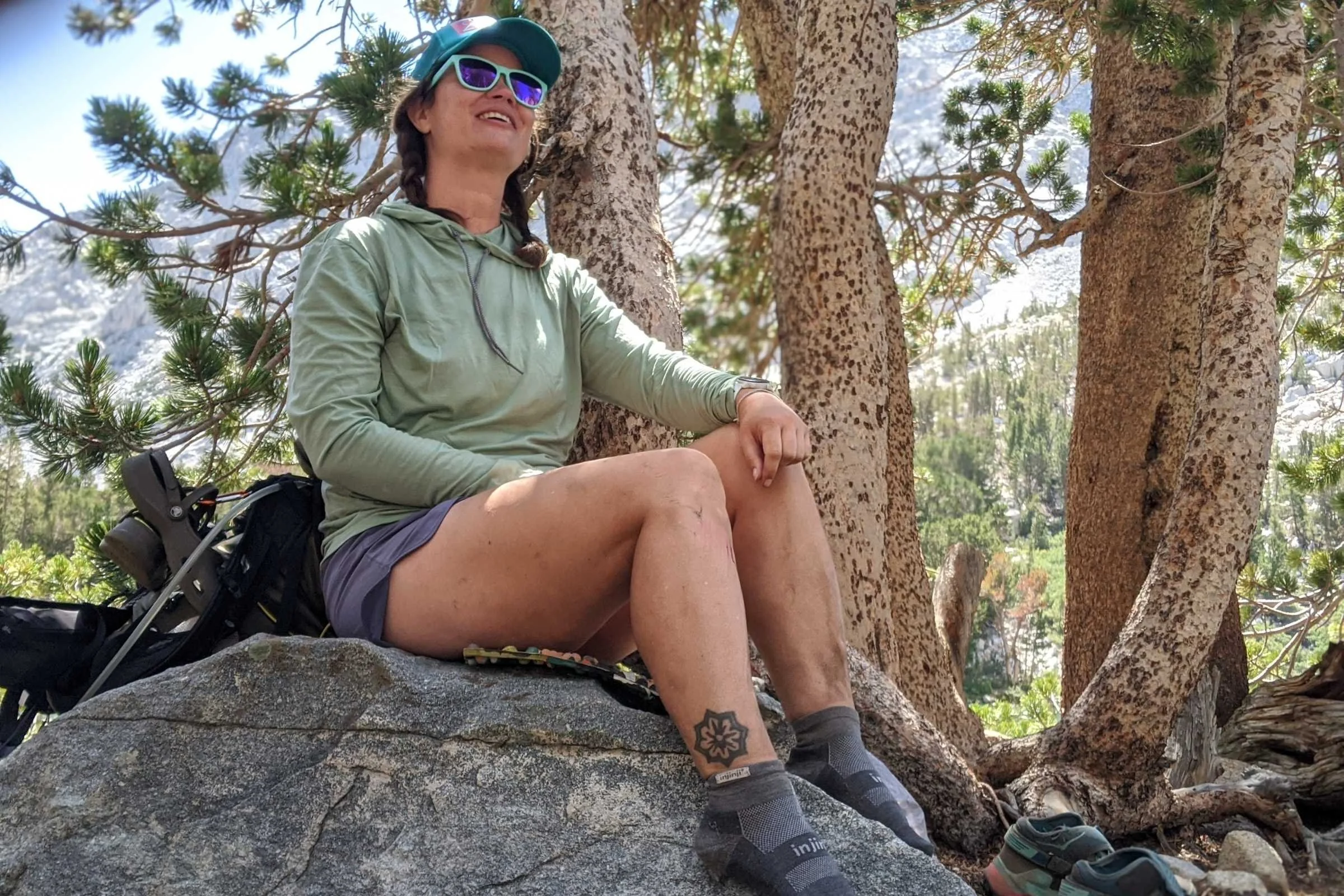 A hiker wearing Injinji toe socks while standing on a rocky trail.