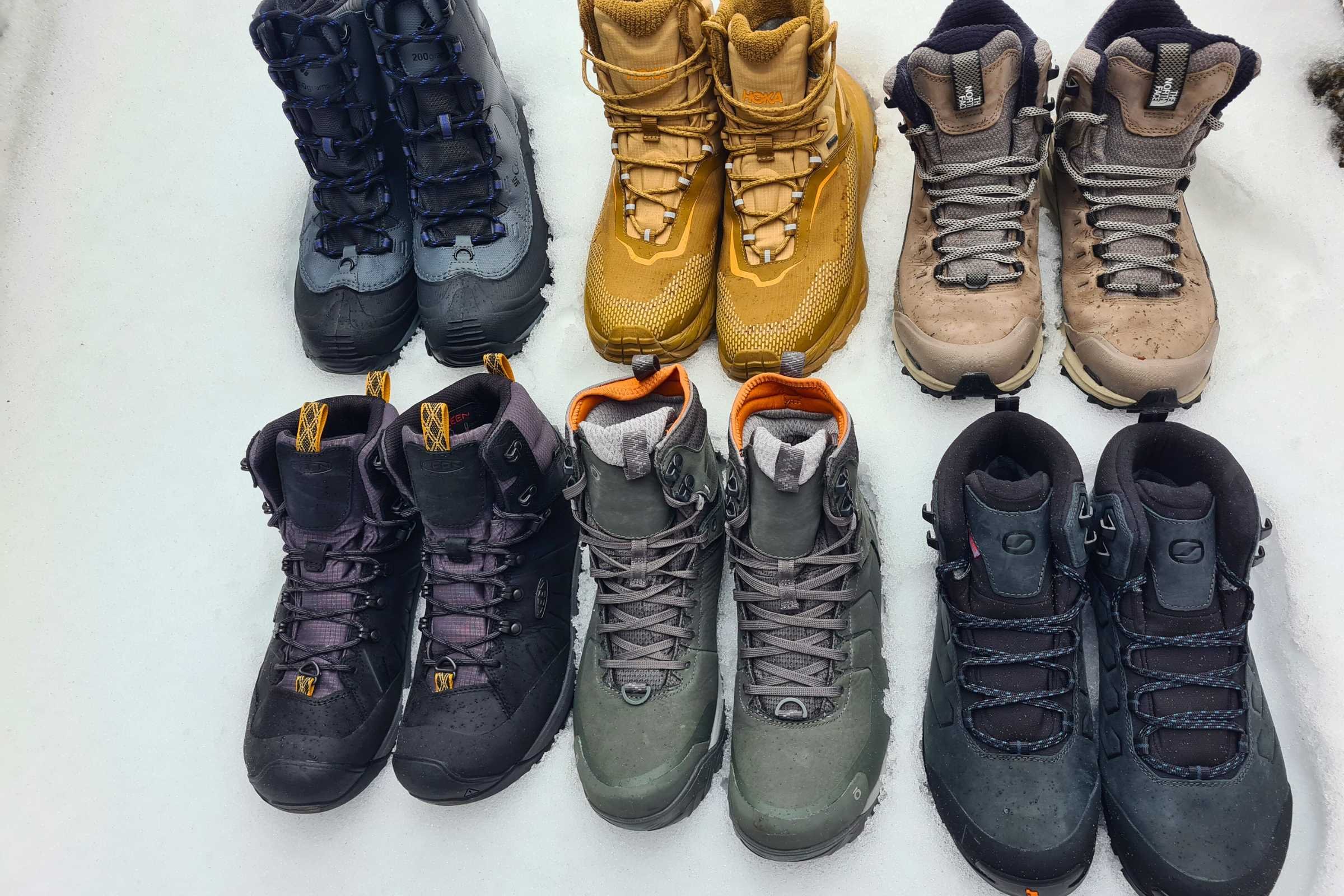 Six different brands of 200g insulated winter hiking boots lined up for comparison.