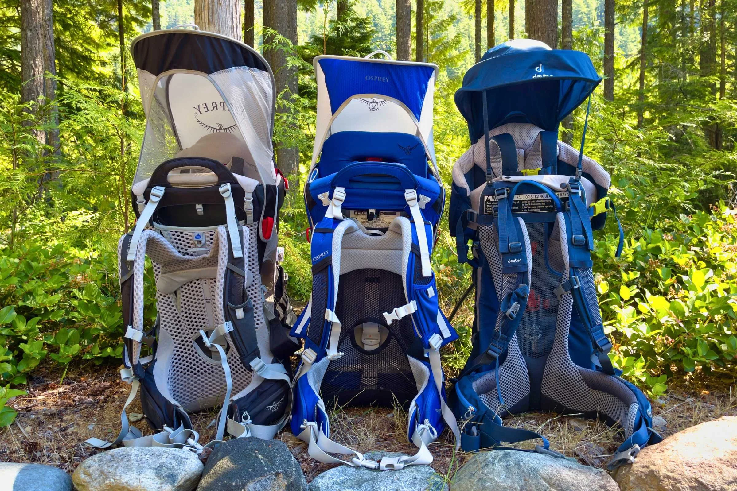 Two different hiking baby carriers standing side-by-side for feature comparison.