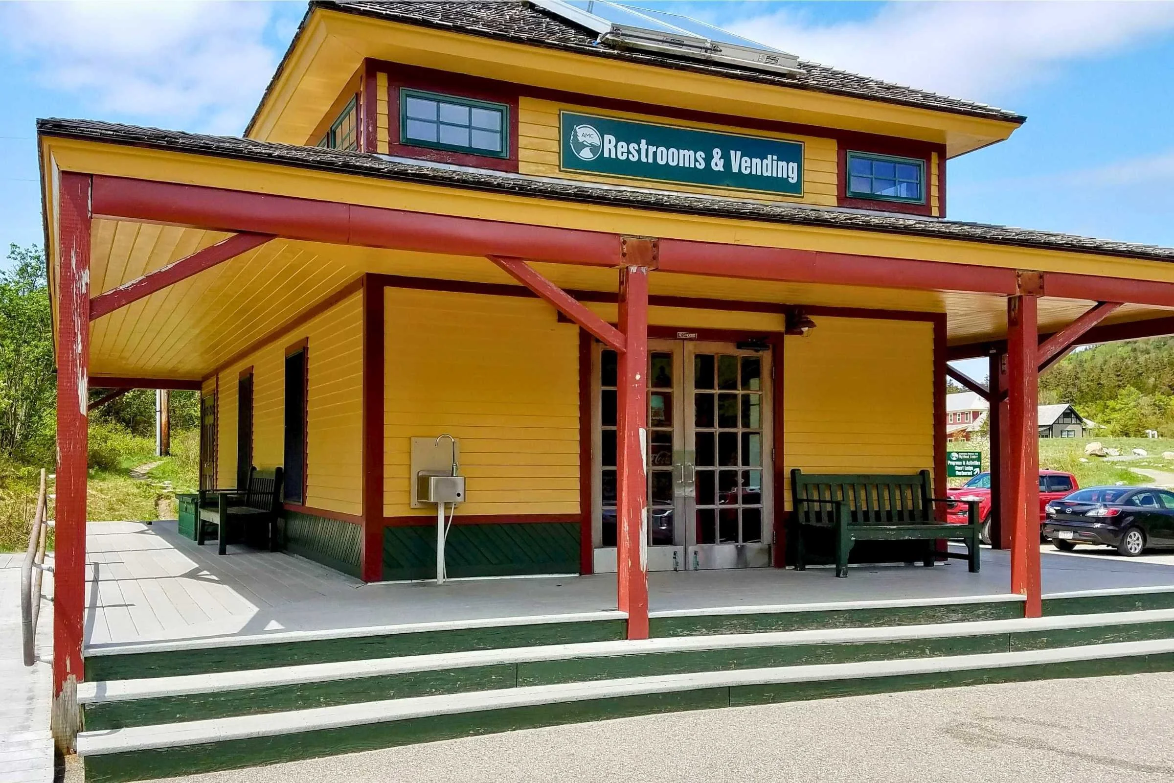 The historic Crawford Notch Depot building at the base of the mountains.