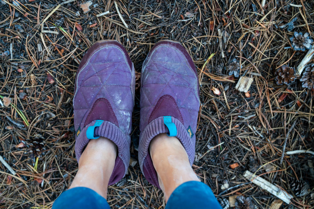 A person wearing Teva ReEmber shoes with thick gray wool socks.