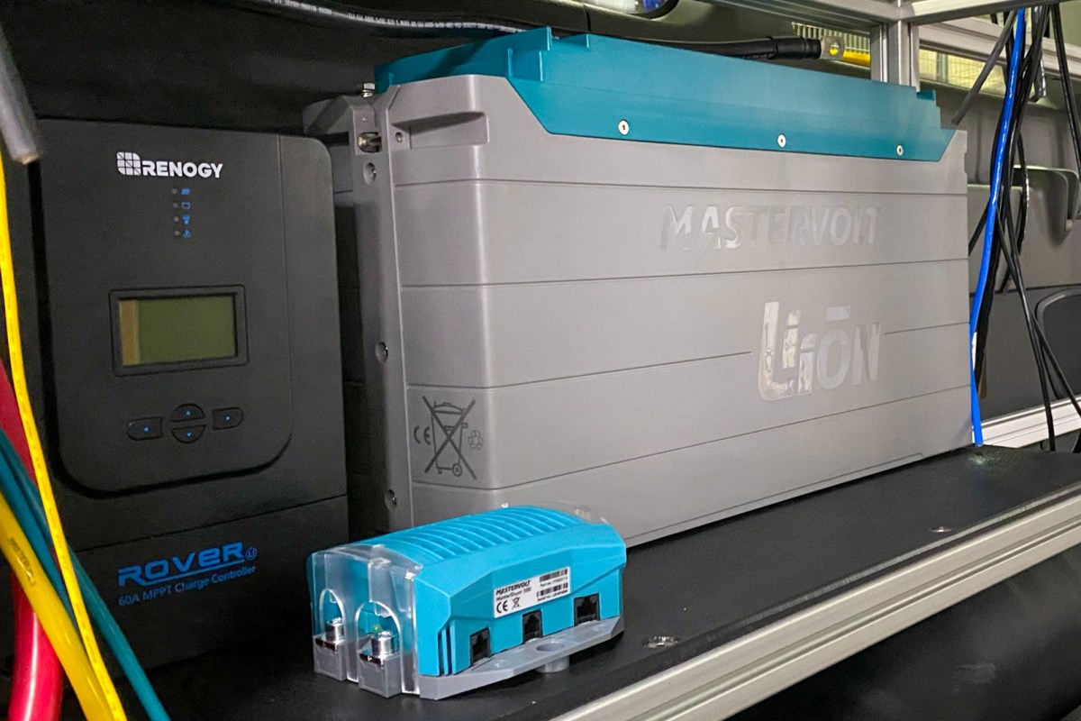 A close-up of a high-capacity lithium-ion battery installed in a campervan power system.