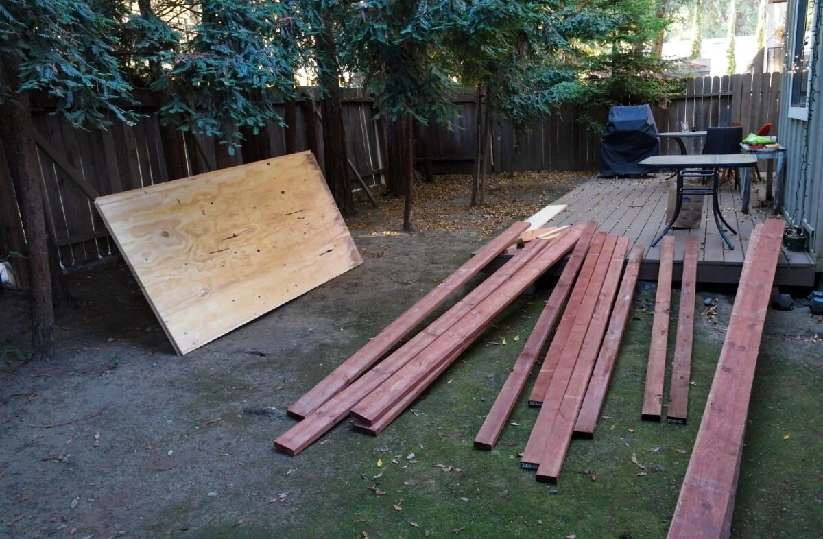 A stack of structural lumber and plywood panels ready for construction.