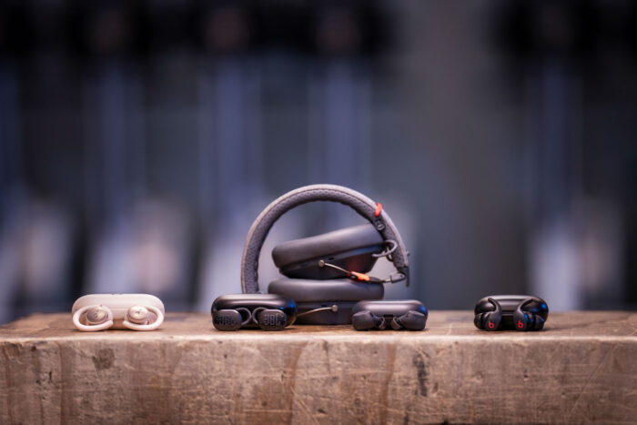 A group of different sports headphone charging cases arranged together.