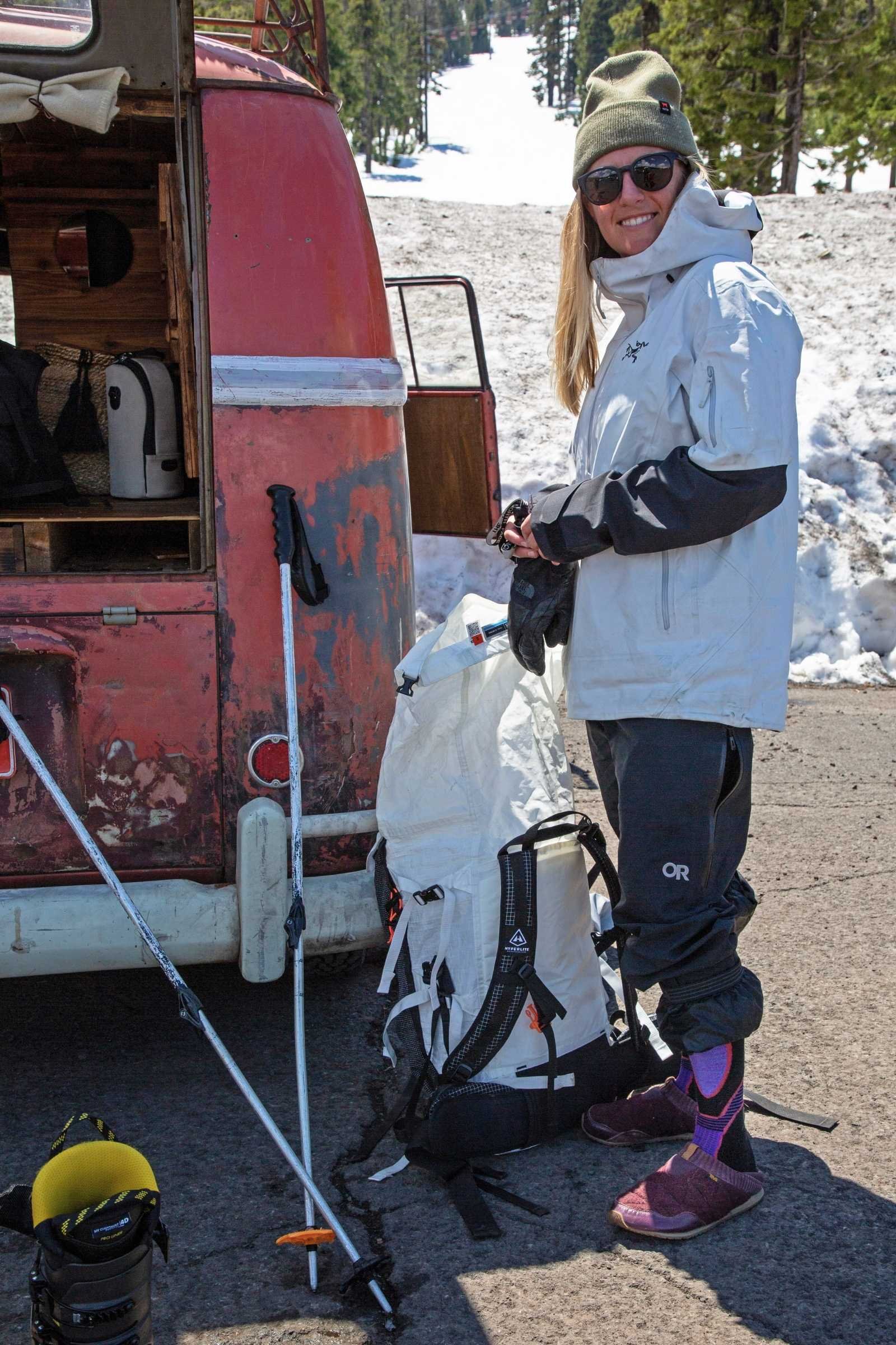 A tester wearing Teva ReEmber slippers while relaxing inside a van.