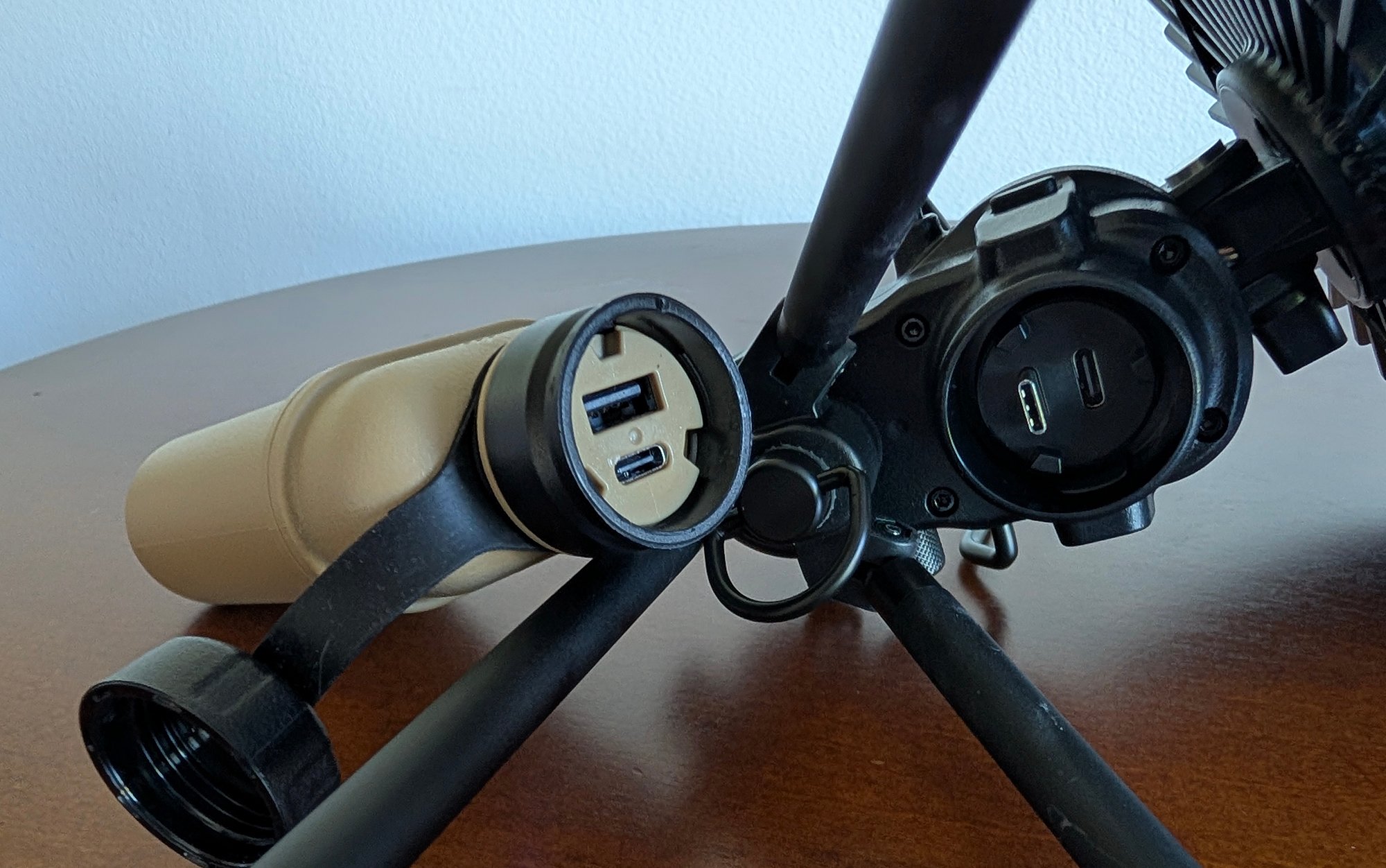 Close-up of the metal charging port on the Nestout camping fan.