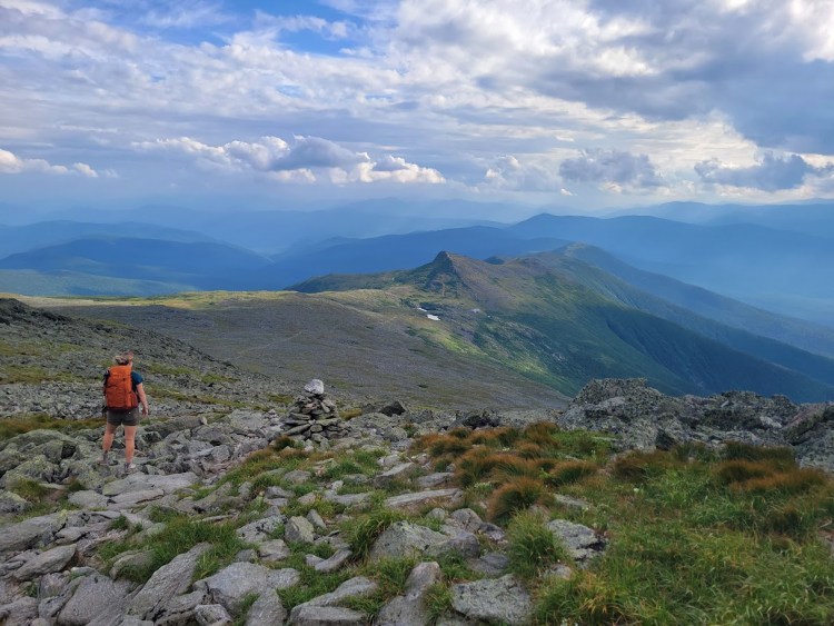 An aerial-style view looking down on the Lake of the Clouds and its hut from the Crawford Path.
